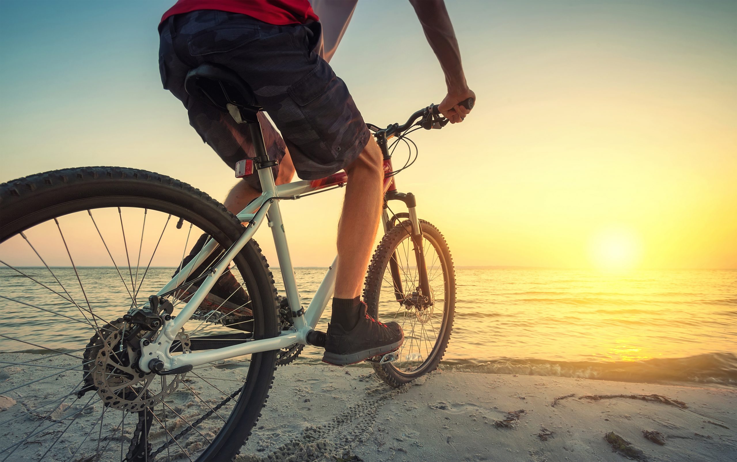 Ride on bike on the beach. Sport and active life concept